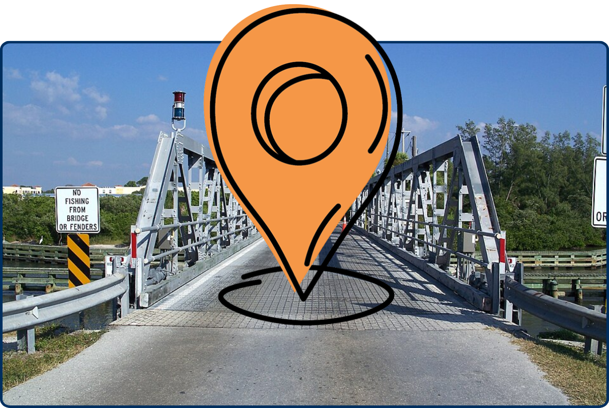 Blackburn Point Bridge in Osprey, Florida with metal trusses, roadway, and clear blue sky.