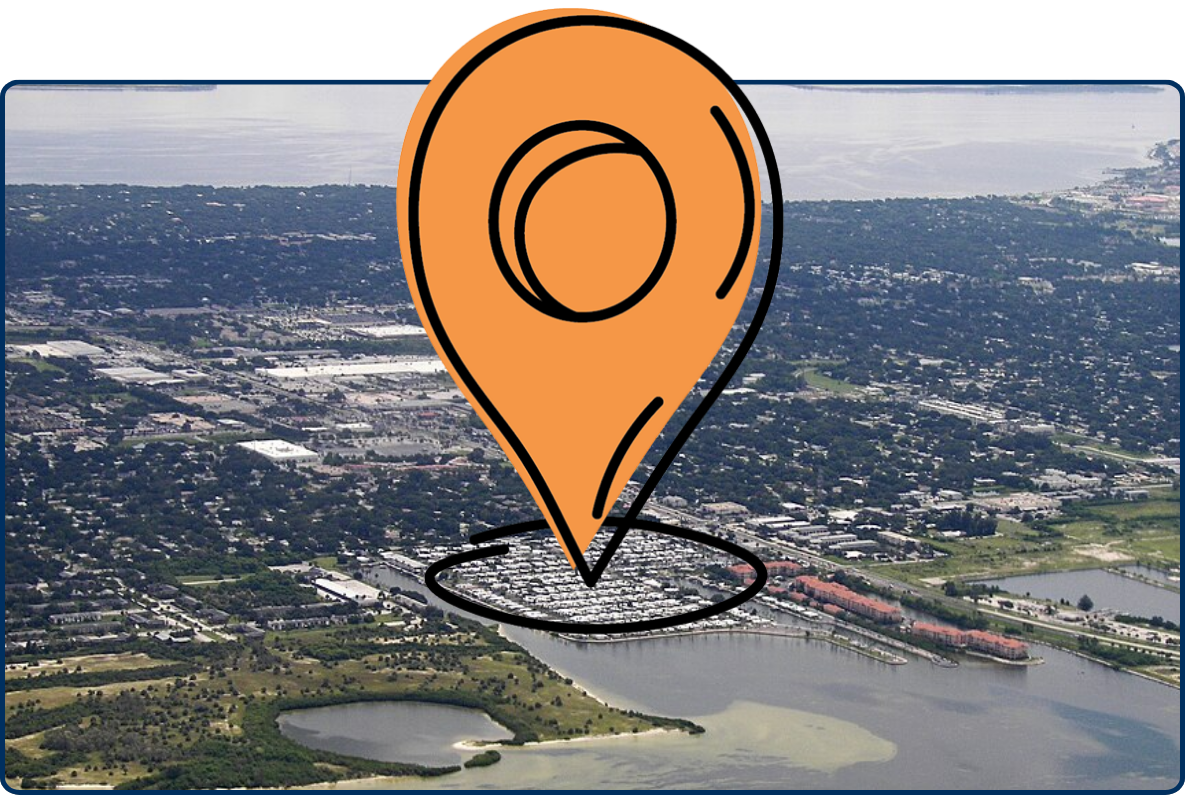 Aerial view of South Tampa near Gandy Bridge with bay waters, marina, shoreline, neighborhoods, and green wetlands.