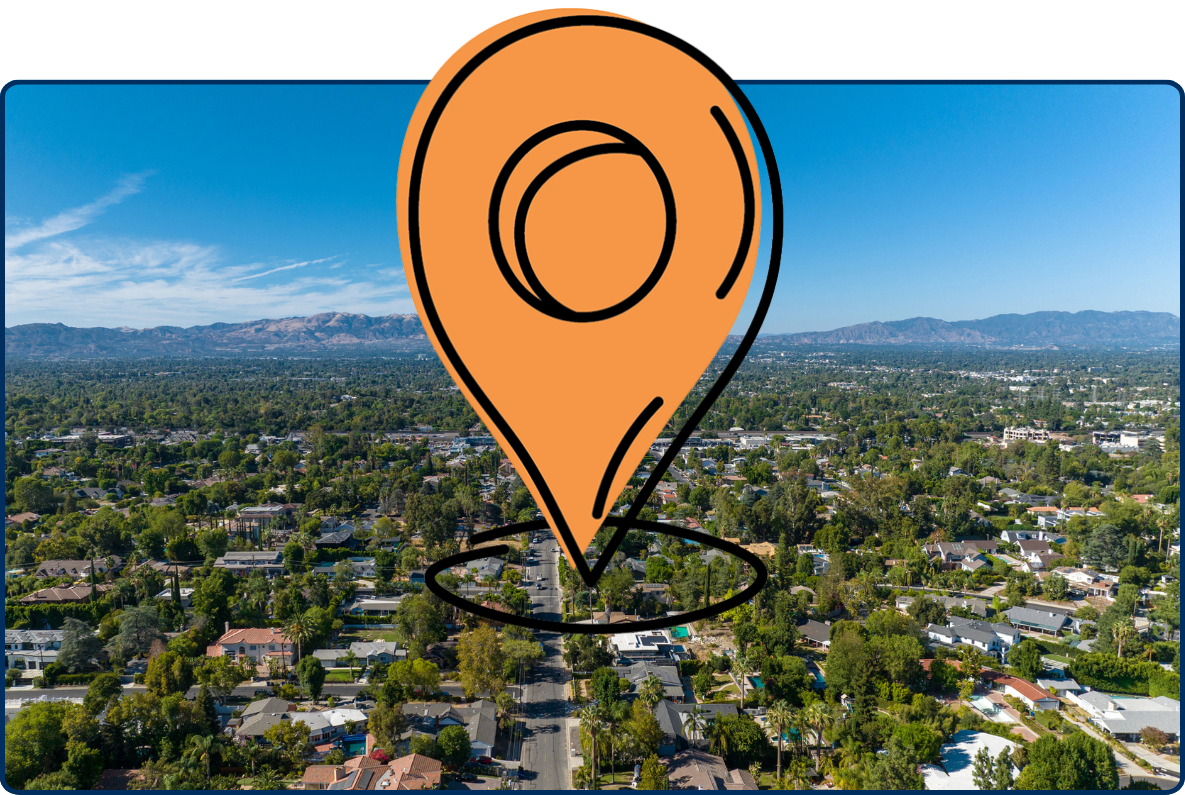 Aerial view of San Fernando Valley in Los Angeles with suburban neighborhoods, roads, and mountains.