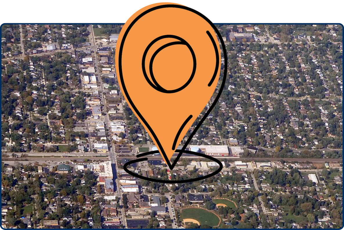 Aerial view of Westmont, Illinois with neighborhoods, roads, trees, and baseball fields.