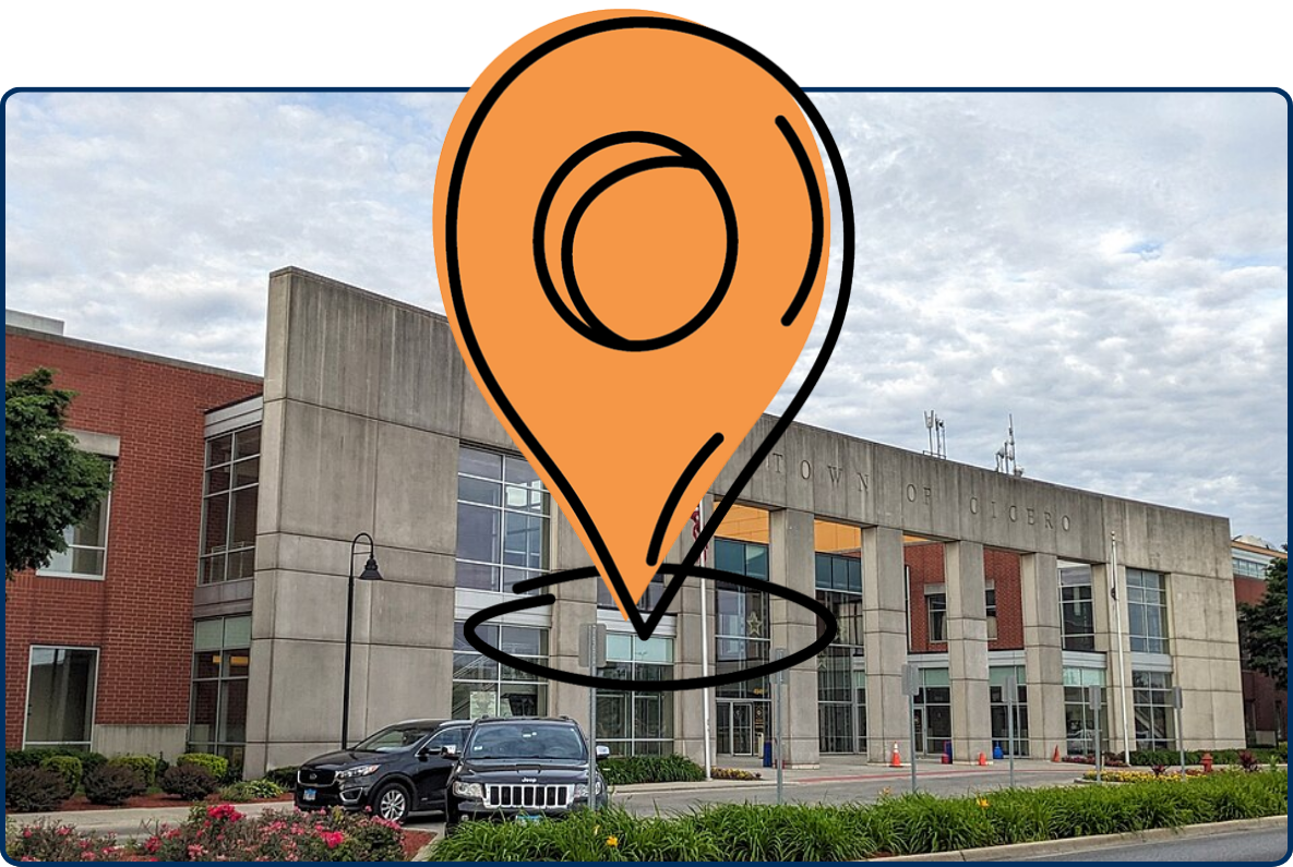 Cicero Town Hall building with modern concrete facade, parked cars, landscaping, and cloudy sky.