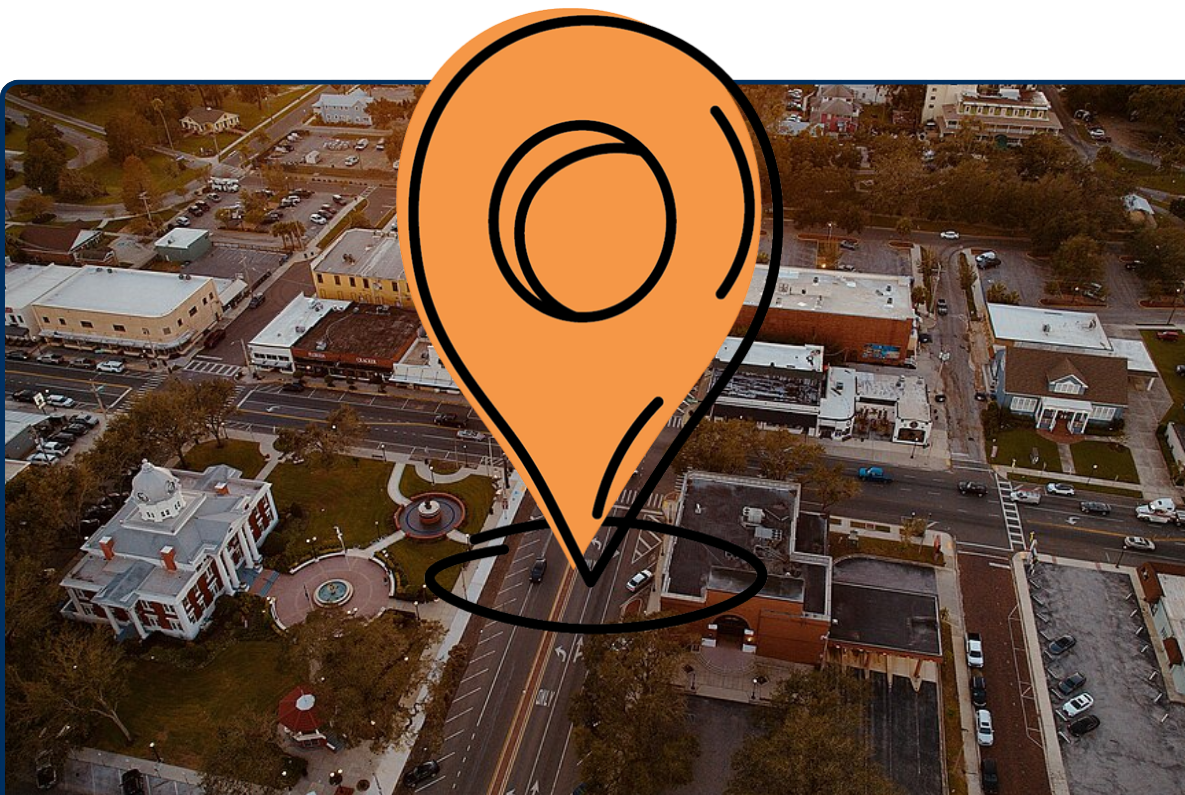 Aerial view of downtown Dade City, Florida, with streets, buildings, cars, and civic square.