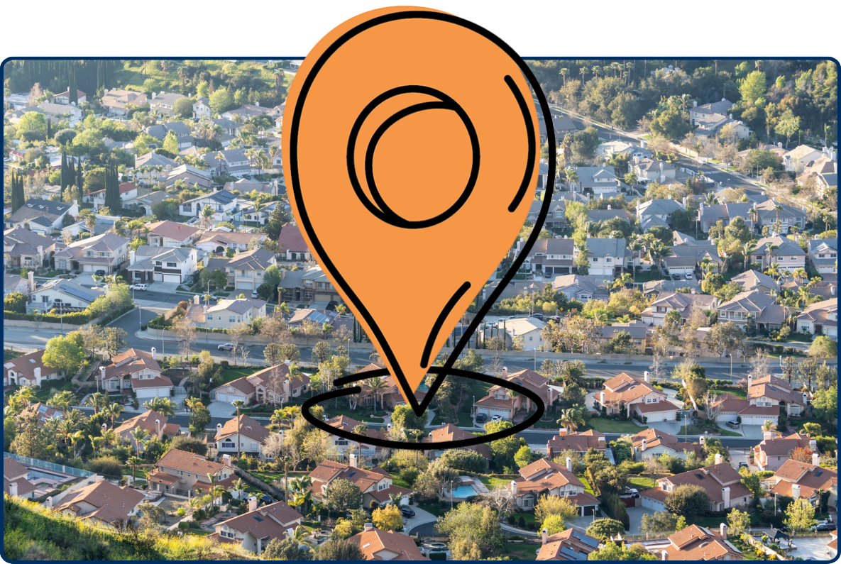 Aerial view of North Los Angeles neighborhoods with hillside greenery, houses, streets, and trees.