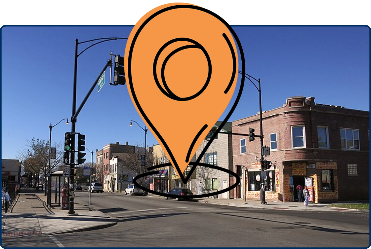 Street intersection at Armitage and Keeler in Chicago’s Hermosa neighborhood, with traffic lights, storefronts, brick buildings, and a Walgreens sign.