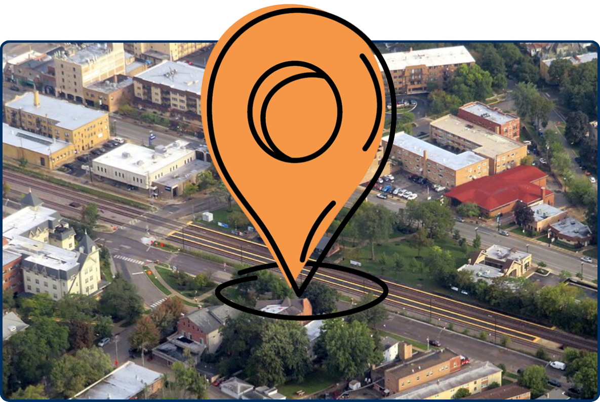 Aerial view of Norwood Park Metra station surrounded by residential streets, commercial buildings, and tree-lined neighborhoods.
