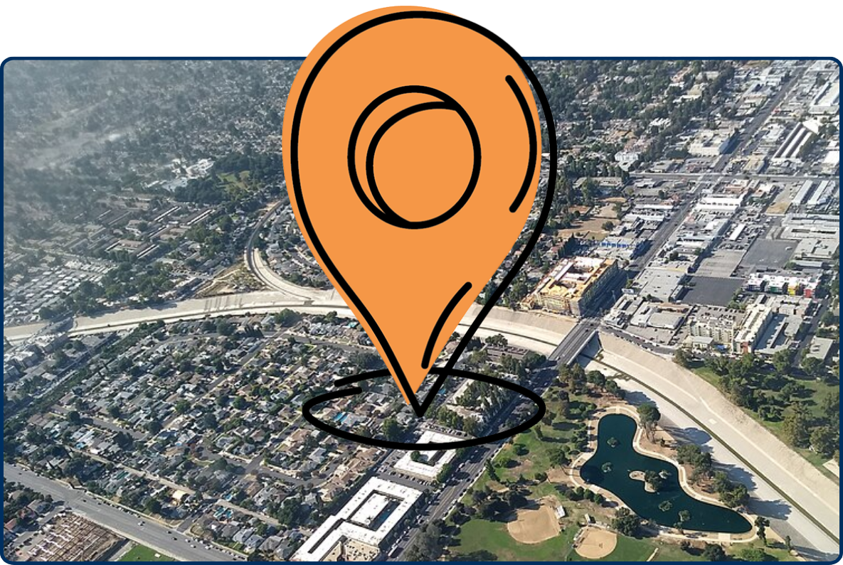 Aerial view of Reseda, Los Angeles, showing the Los Angeles River channel, roads, neighborhoods, industrial buildings, and park facilities.