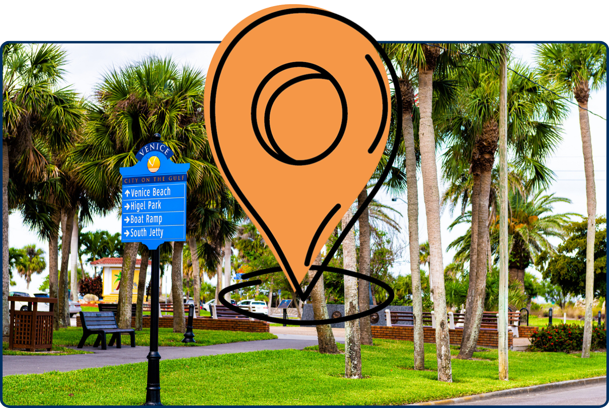 Palm-lined park in Venice, Florida, with directional signs to Venice Beach, Higel Park, boat ramp, and South Jetty.