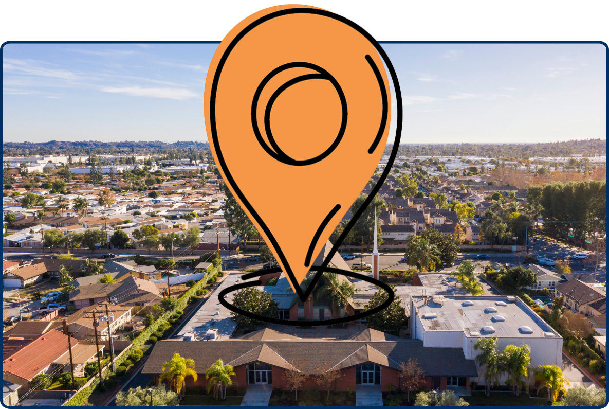 Aerial view of Brea, California, with residential neighborhoods, a church in the foreground, and commercial areas stretching into the distance.