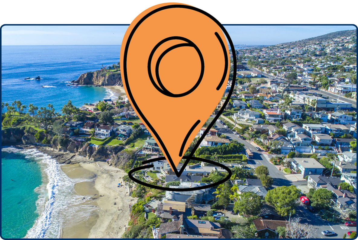 Aerial view of Laguna Beach, California, showing turquoise ocean water, sandy coves, rocky cliffs, and hillside coastal homes.