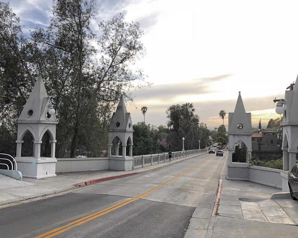 Shakespeare Bridge in Los Angeles, featuring Gothic-style towers, arched openings, and a roadway lined with trees.