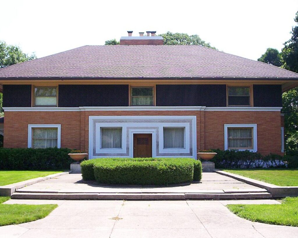 Front facade of the William H. Winslow House, a two-story brick home with a broad hipped roof and landscaped lawn.