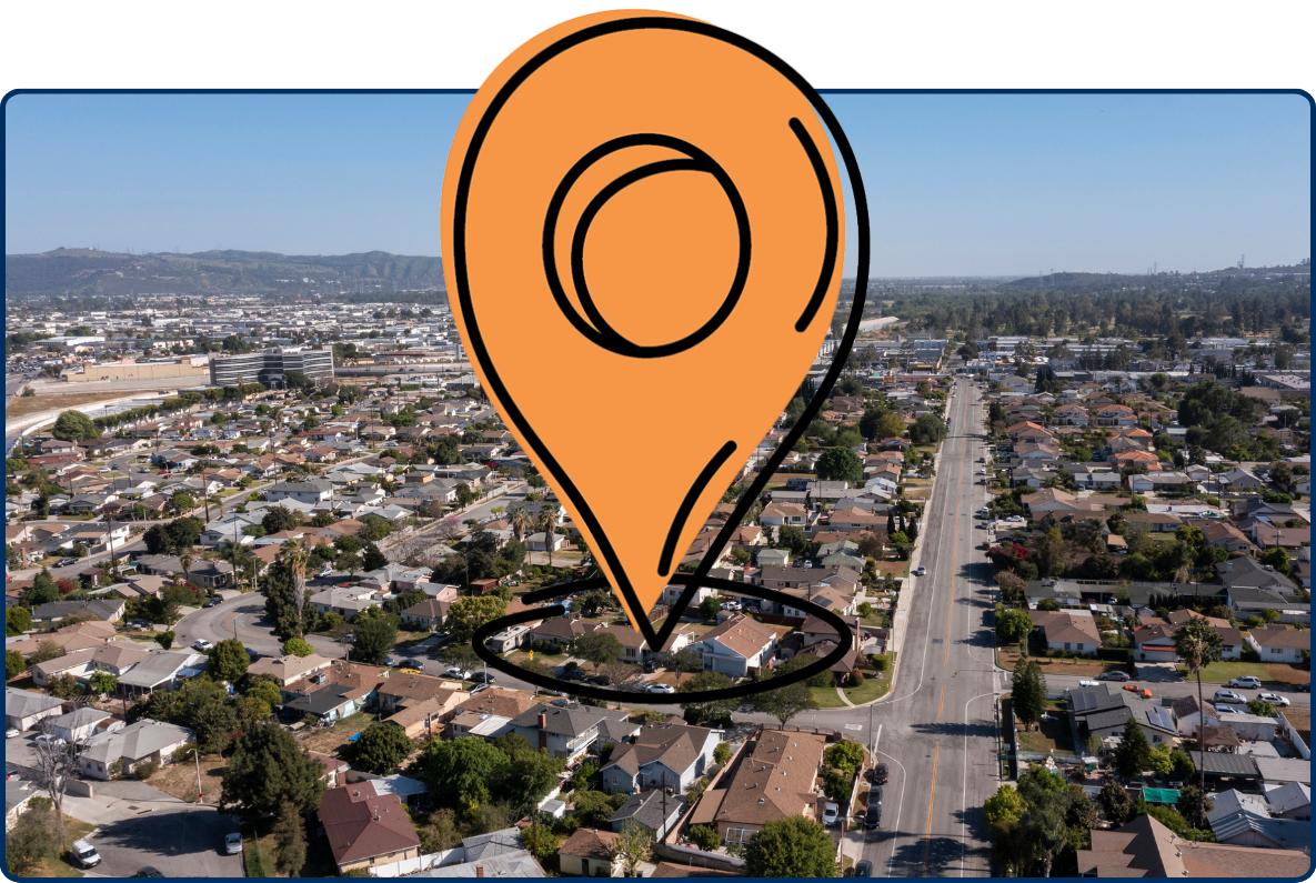 Aerial view of Rosemead, California, showing dense residential neighborhoods, wide roads, commercial areas, and distant hills under a clear blue sky.