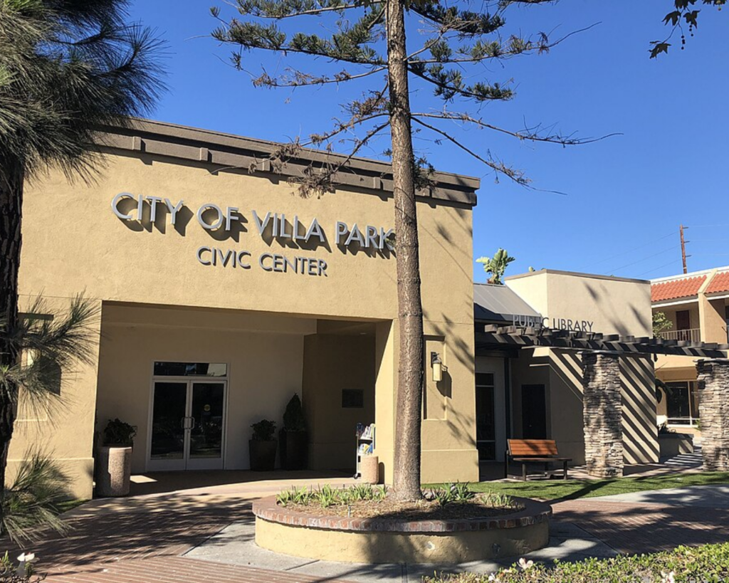 Villa Park Civic Center in California, featuring the City Hall and public library buildings with landscaped trees and a shaded entrance.