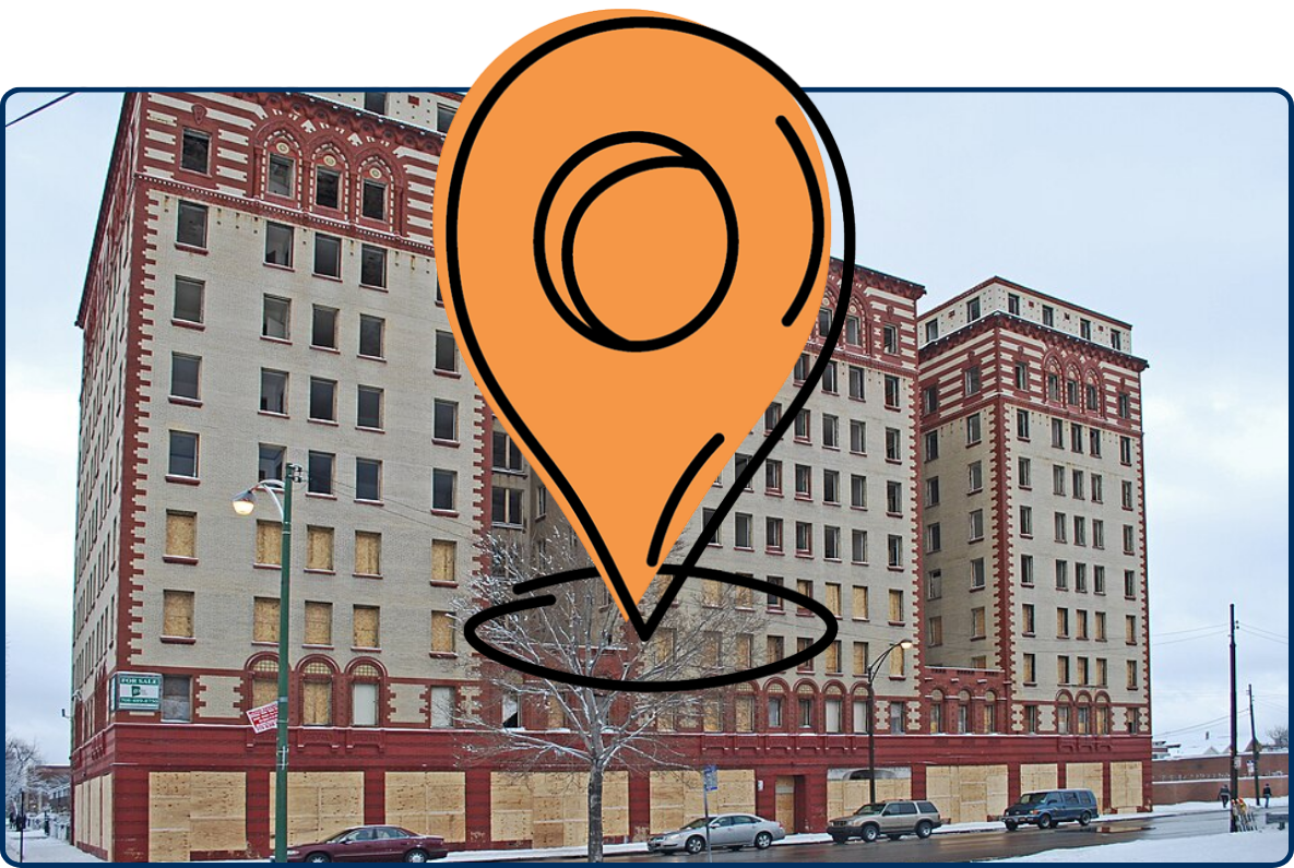 Boarded-up historic Guyon Hotel with red-and-cream brick towers on a snowy Chicago street.
