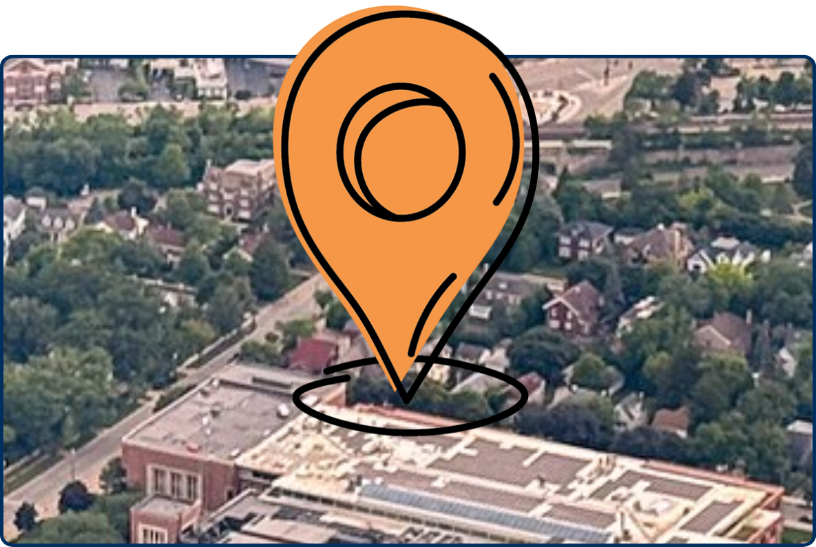 Aerial view of New Trier High School in Winnetka, Illinois, with a blue running track, athletic fields, tennis courts, and surrounding residential neighborhoods.