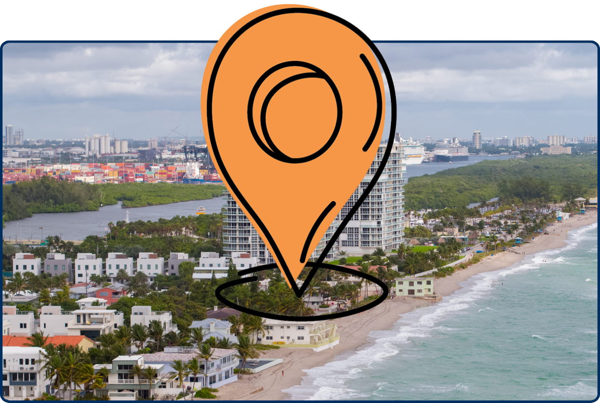 Aerial view of Dania Beach, Florida, showing the fishing pier, sandy shoreline, ocean waves, beachfront homes, high-rise buildings, and nearby port facilities.