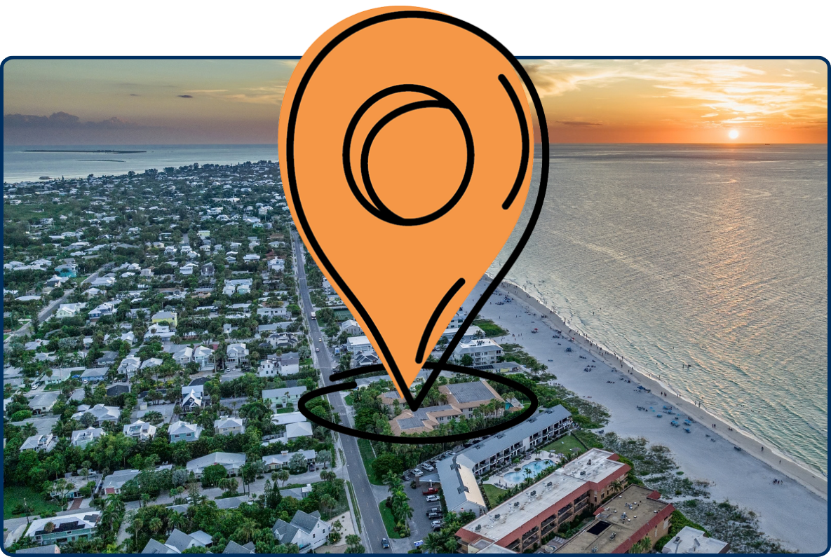 Aerial sunset view of Bean Point on Anna Maria Island, Florida, showing a curving sandy shoreline, coastal homes, and calm Gulf waters glowing beneath the evening sky.