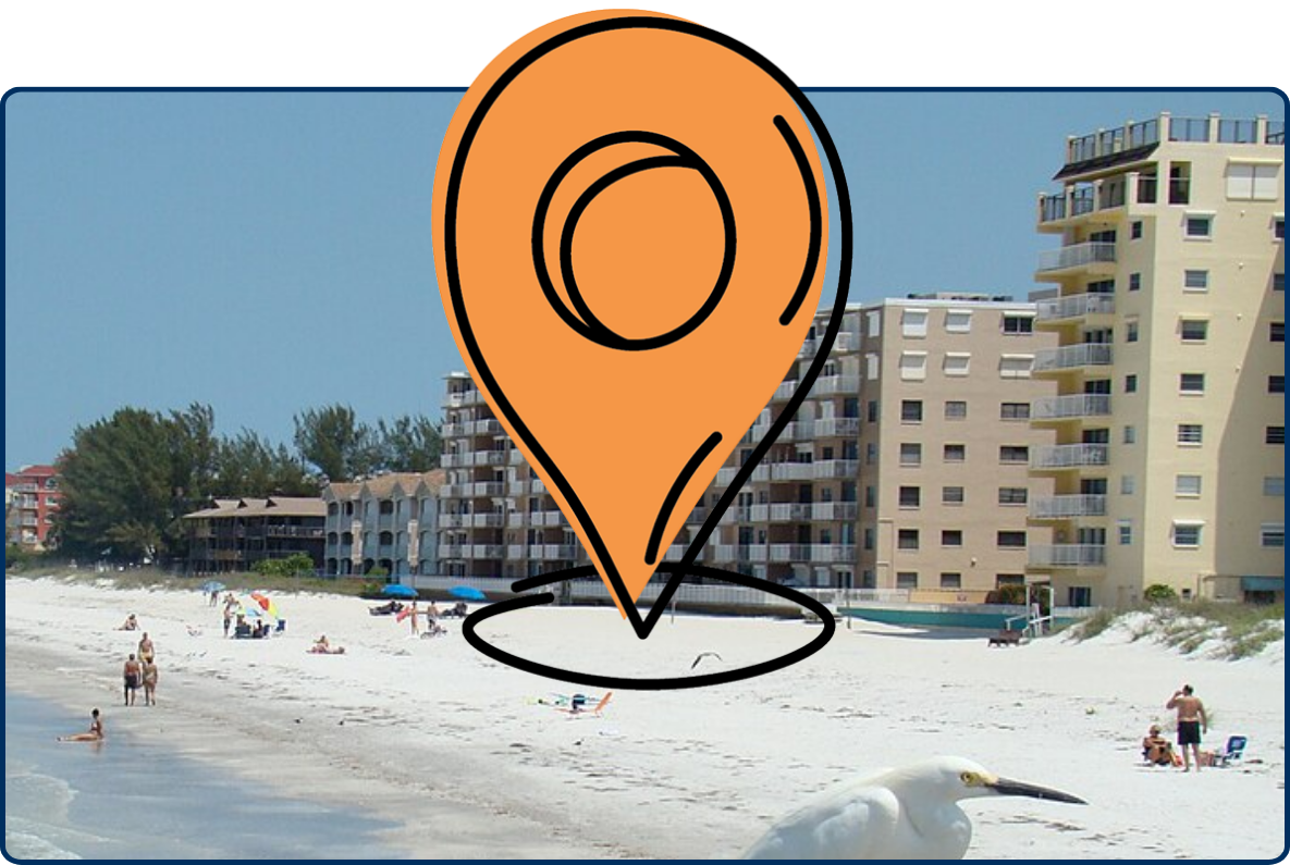 Indian Shores Beach, Florida, with beachfront condominiums, people along the white sandy shoreline, gentle Gulf waves, and a white egret perched on a wooden railing in the foreground.