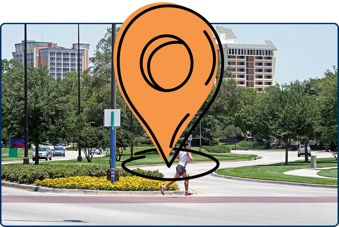 Hotel Plaza Boulevard in Lake Buena Vista, Florida, with landscaped roads, trees, hotel buildings, and a jogger crossing the street.
