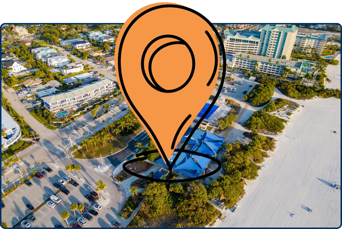 Aerial view of Lido Key Beach in Sarasota, Florida, showing the beach pavilion, parking areas, nearby hotels and residences, and a wide white sandy shoreline.