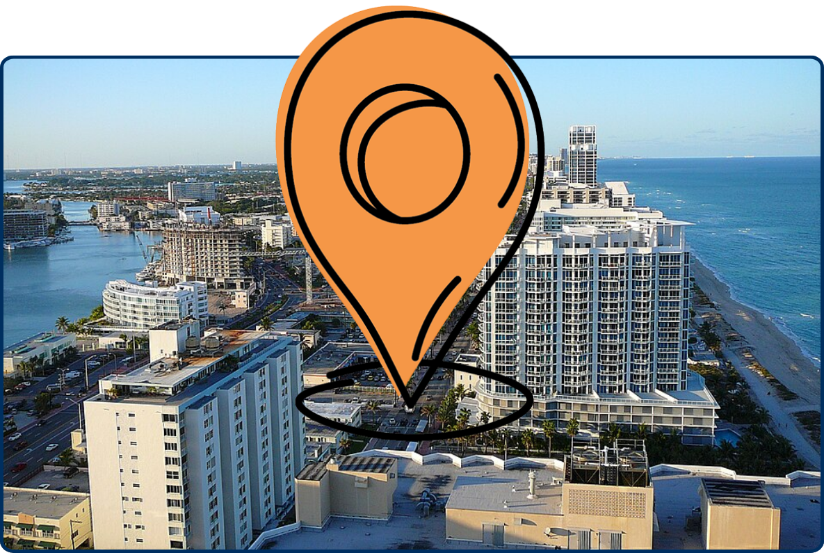 Aerial view of North Beach in Miami Beach, Florida, showing high-rise buildings, waterways, dense urban development, and the Atlantic Ocean along the coastline.