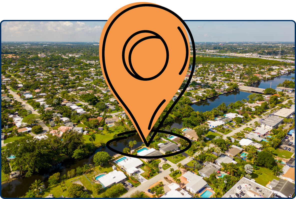Aerial view of Wilton Manors, Florida, showing tree-lined residential neighborhoods, winding waterways, bridges, and scattered homes beneath a partly cloudy sky.