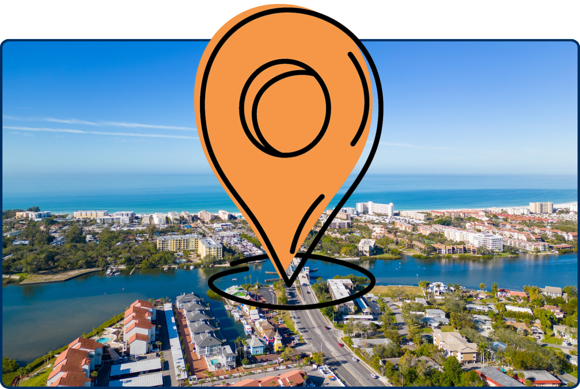 Aerial view of Siesta Key, Florida, showing coastal neighborhoods, bridges, waterways, beachfront buildings, and the blue Gulf of Mexico beneath a clear sky.