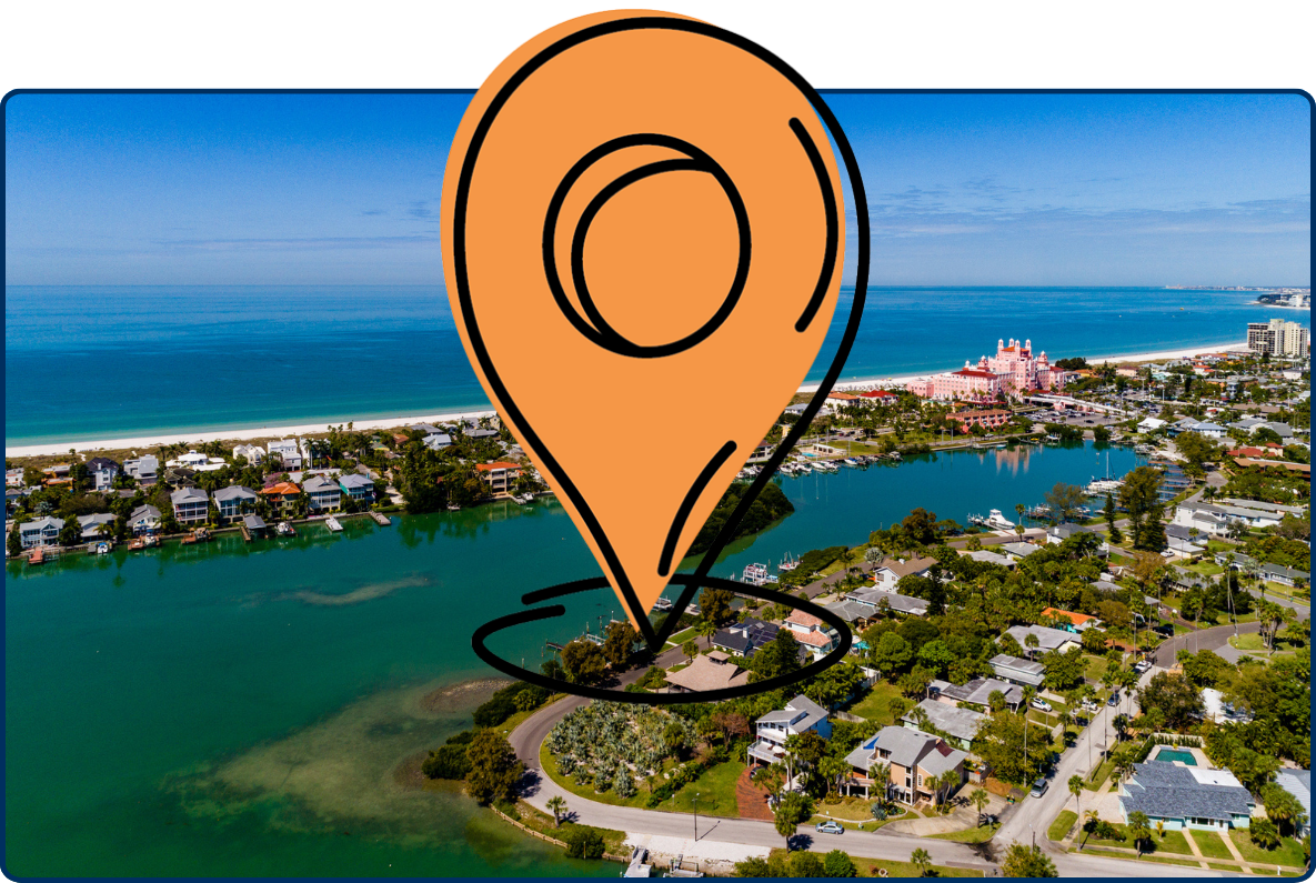 Aerial view of St. Pete Beach, Florida, showing the Gulf coastline, turquoise waterways, waterfront neighborhoods, and the pink Don CeSar hotel along the shore.