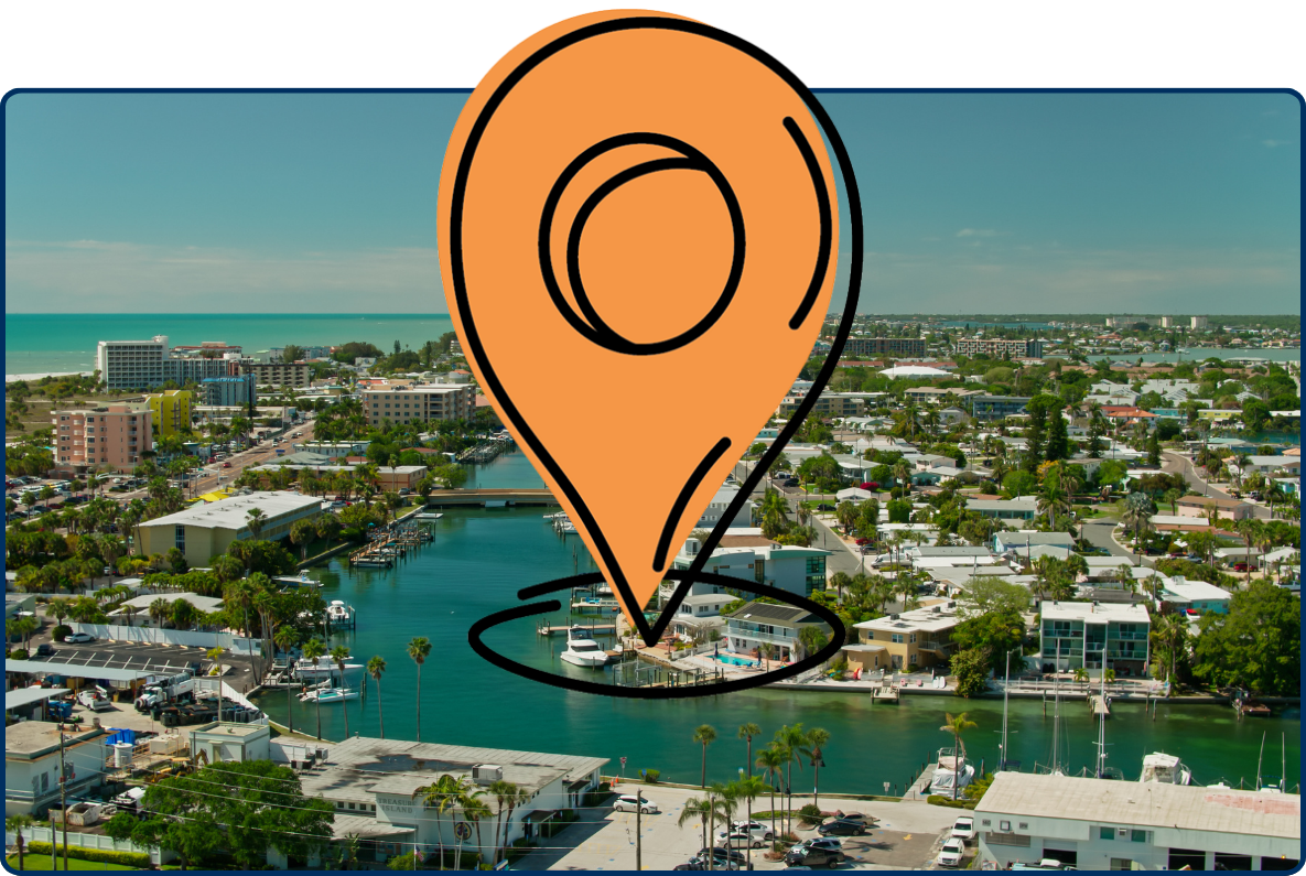 Aerial view of Treasure Island, Florida, showing turquoise canals, waterfront homes, marinas, low-rise buildings, and the Gulf of Mexico along the coastline.